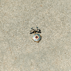 Decorative pendant on a sandy surface