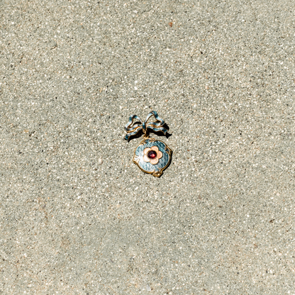 Decorative pendant on a sandy surface