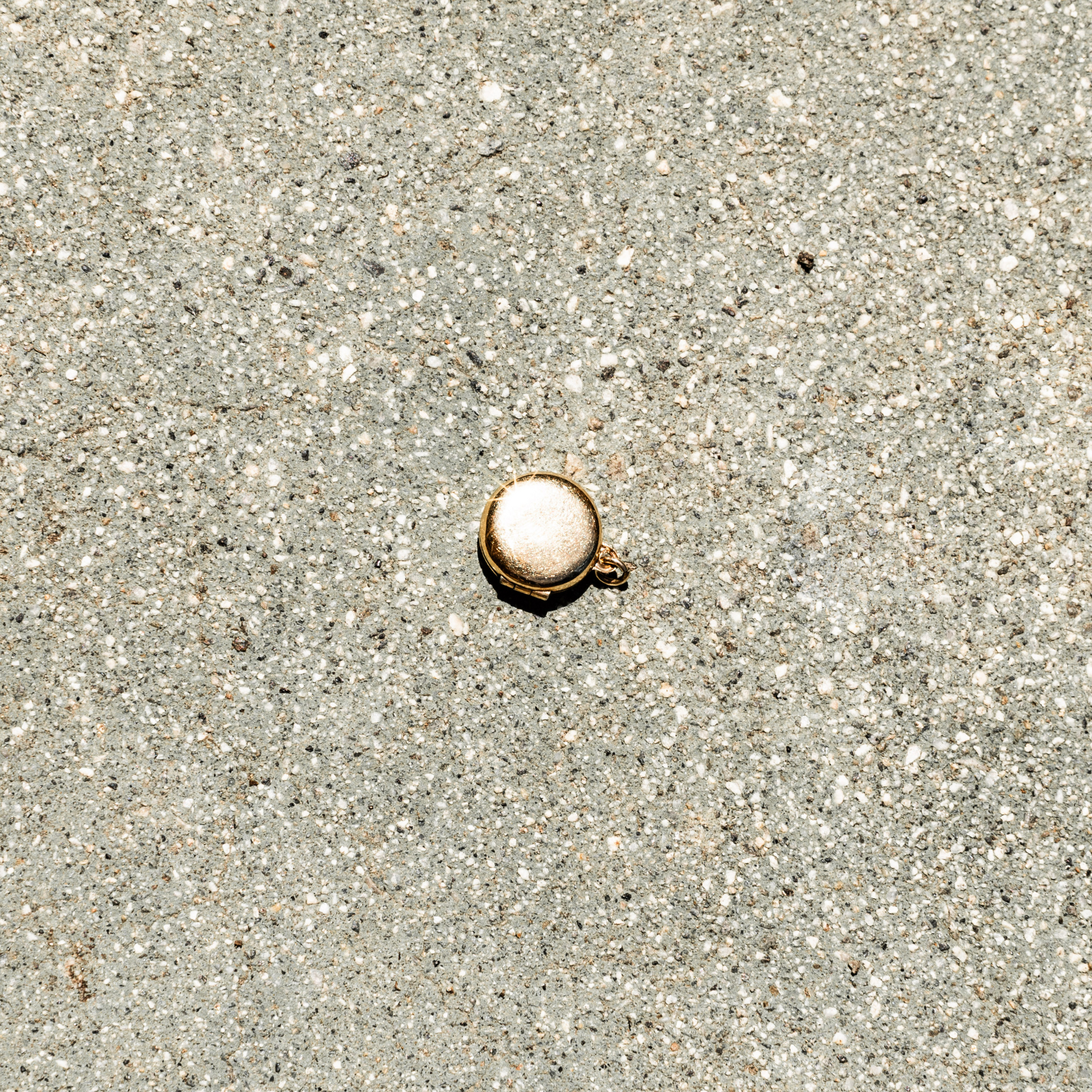 Small round object on sandy ground