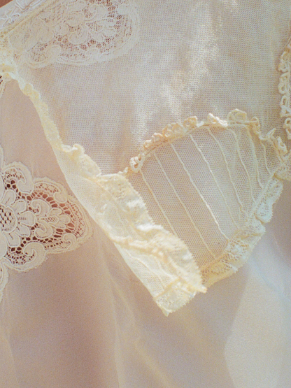 Close-up of lace detailing on a sheer fabric