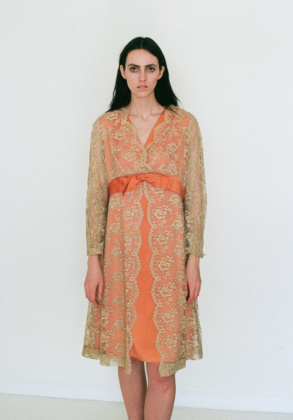 Woman wearing a patterned dress with a plain background