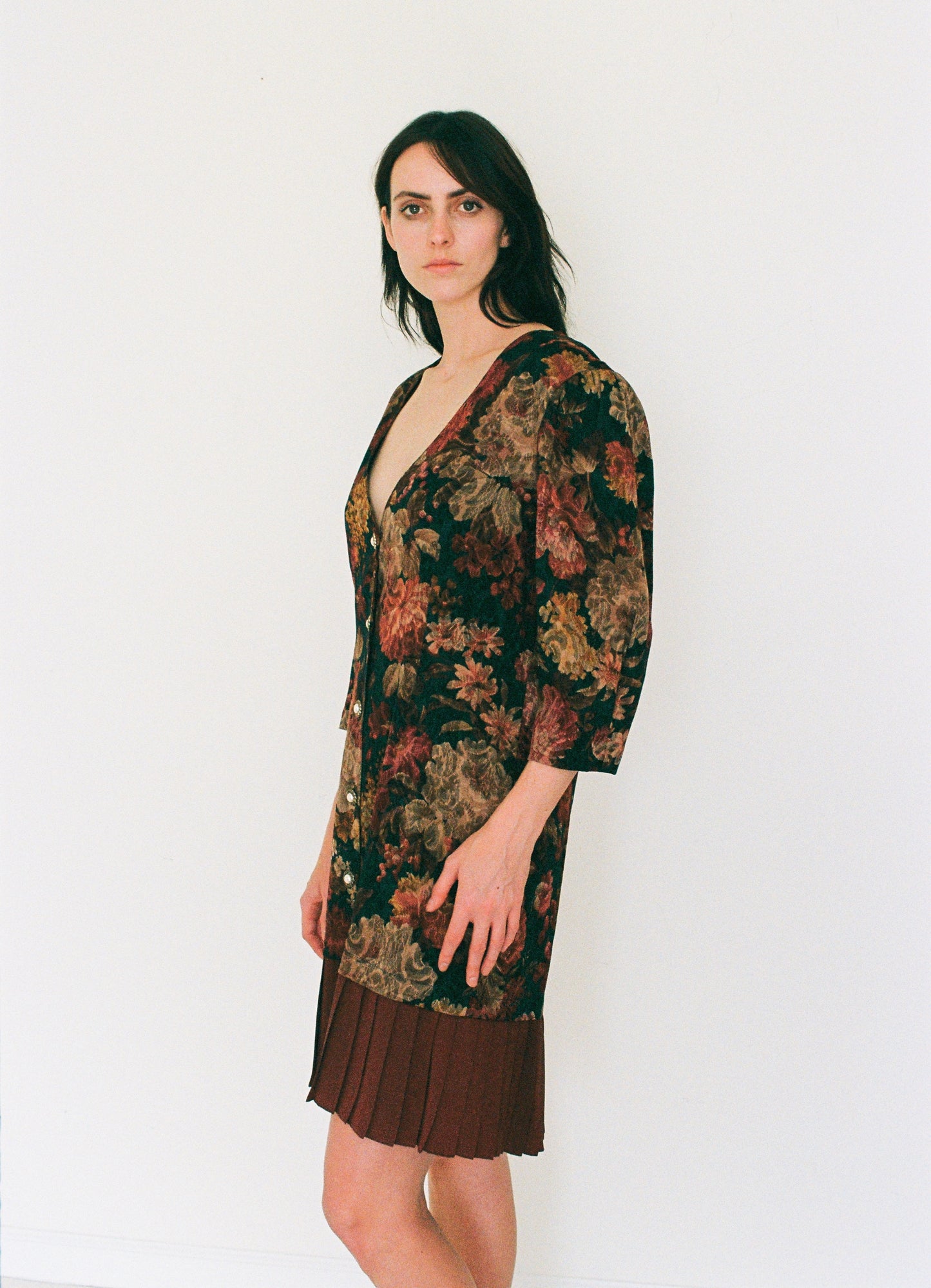 Woman wearing a floral dress with a plain white background