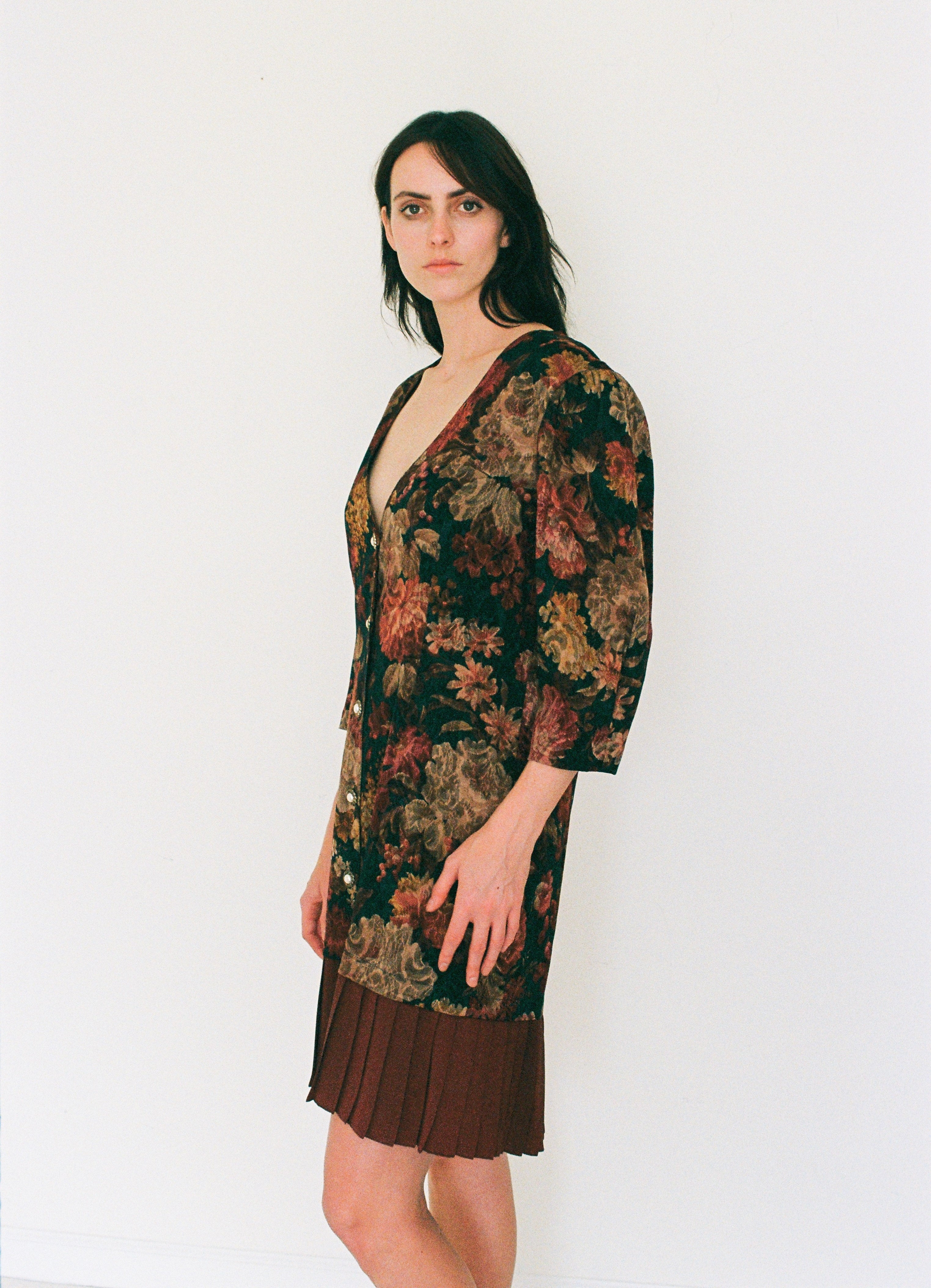 Woman wearing a floral dress with a plain white background