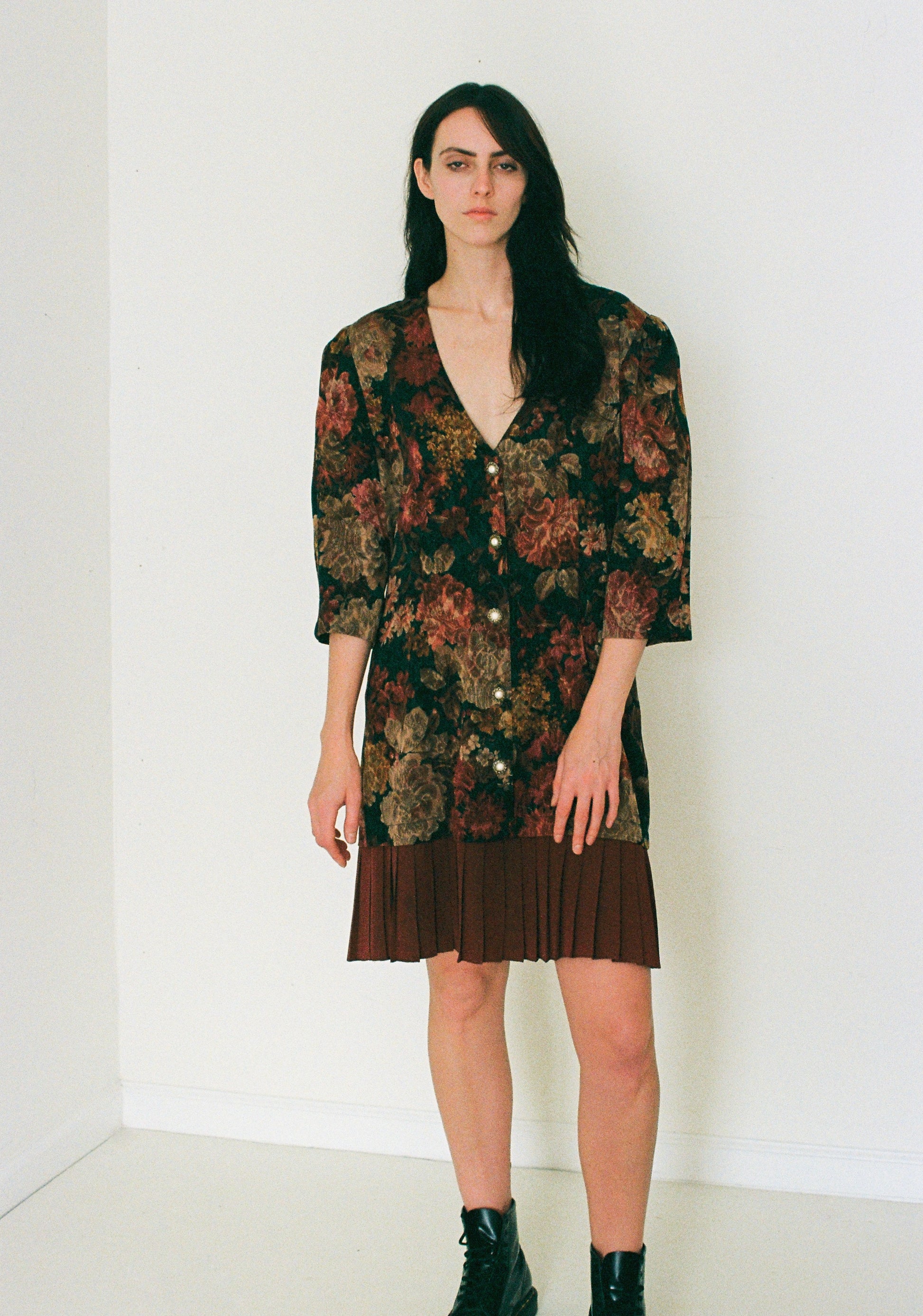 Woman wearing a floral dress with a plain white background