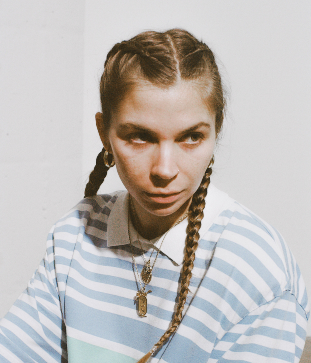 Person wearing a striped shirt with a plain background