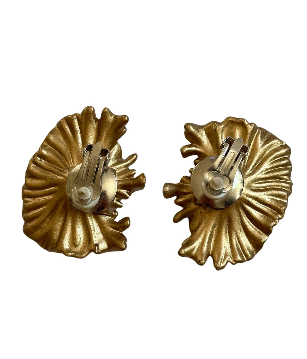Pair of gold shell-shaped earrings on a white background