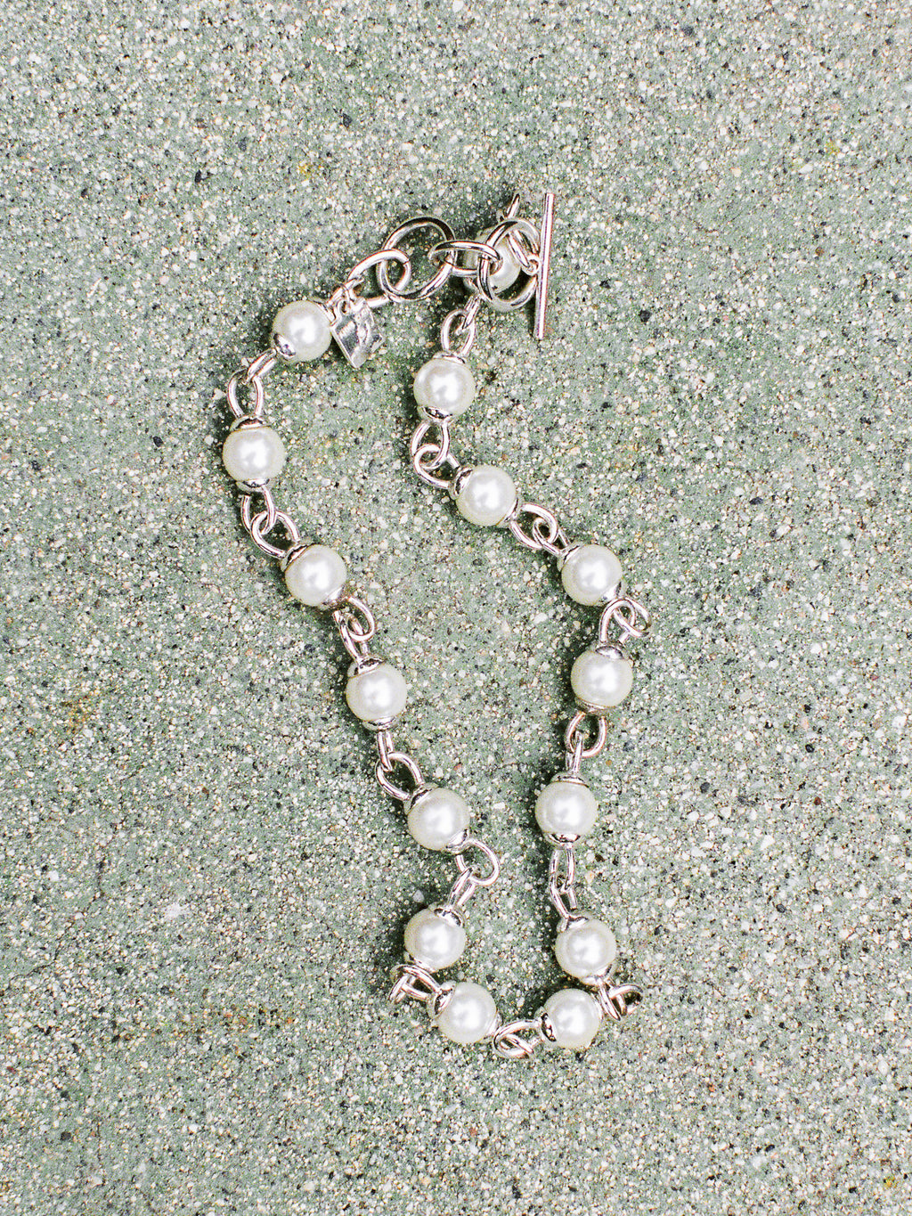Pearl bracelet on a textured surface