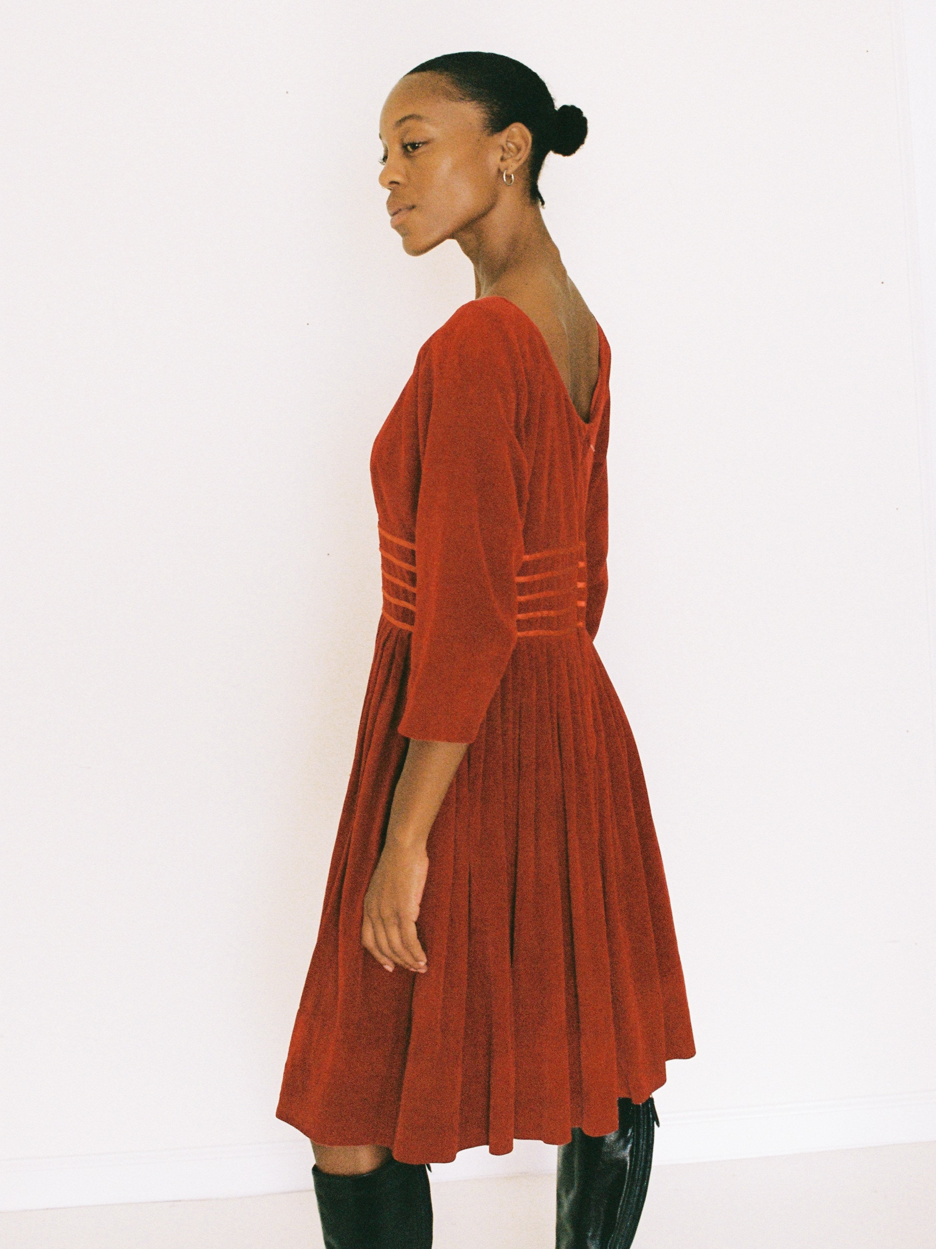 Woman wearing a red dress against a white background