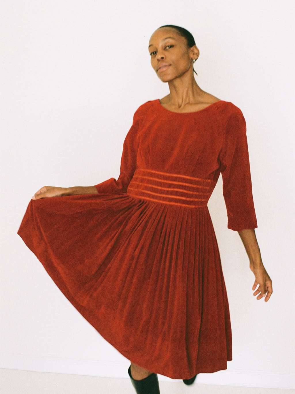Woman wearing a red velvet dress on a white background