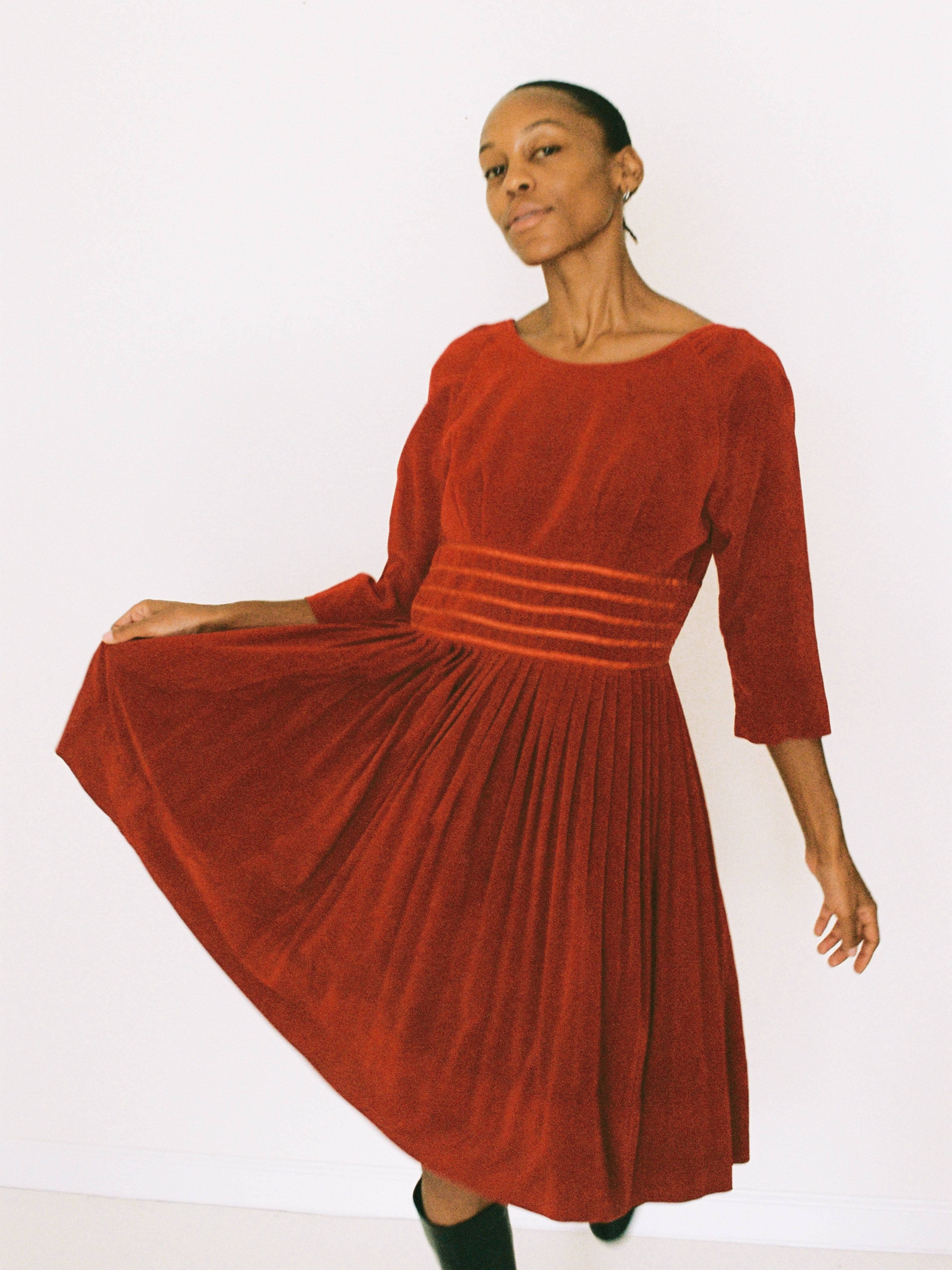 Woman wearing a red velvet dress on a white background