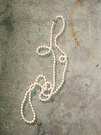 Pearl necklace on a textured surface