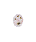 Decorative brooch with pink floral design and gold accents on a white background