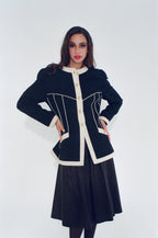Woman wearing a black and white dress with a white background