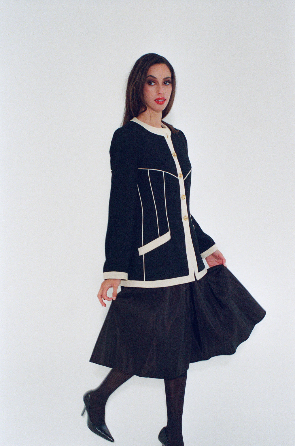 Woman wearing a black and white outfit on a white background
