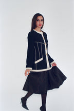 Woman wearing a black and white outfit on a white background