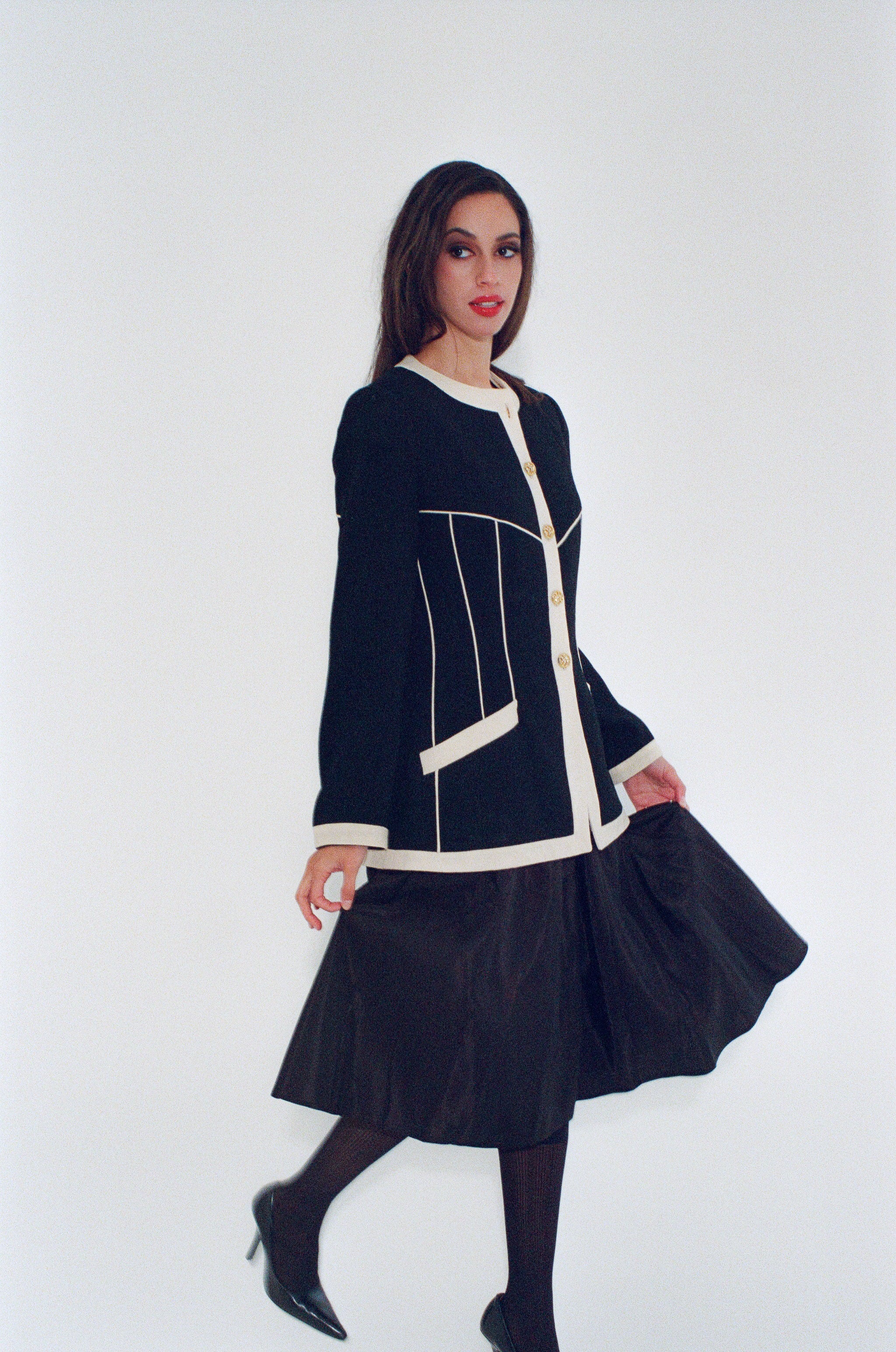 Woman wearing a black and white outfit on a white background