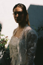 Woman wearing a lace outfit with a blurred background