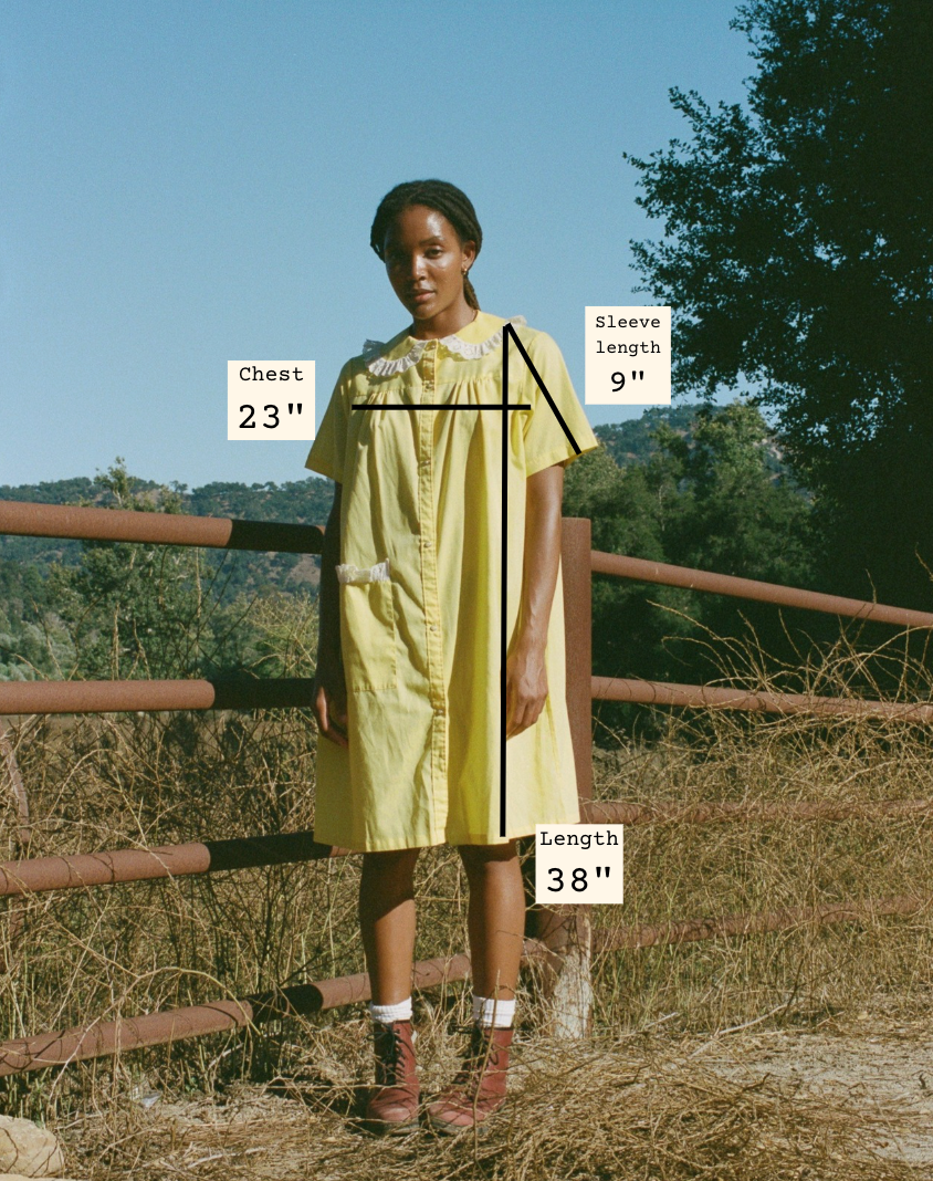 Person wearing a yellow dress with measurements labeled outdoors.