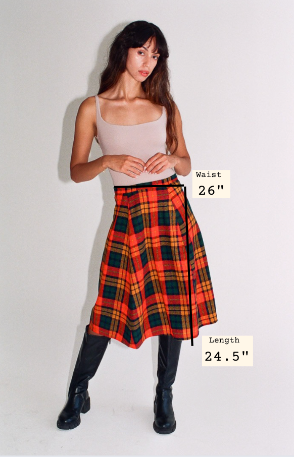 Woman wearing a plaid skirt with measurements displayed on a white background