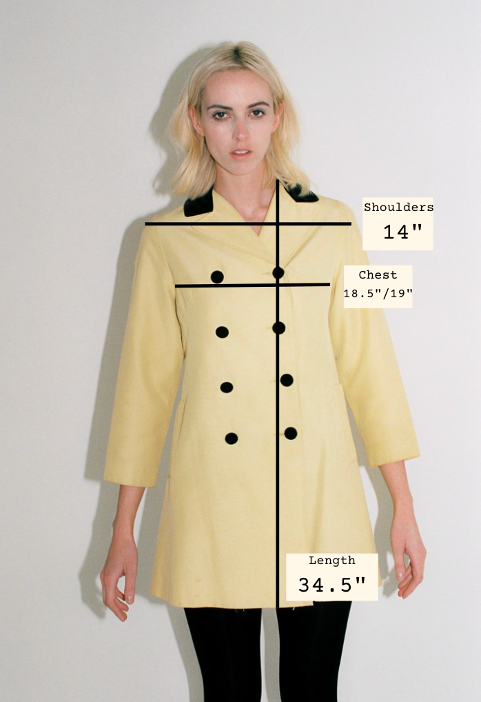 Woman wearing a yellow coat with measurements labeled on a plain background
