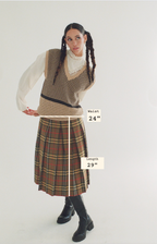Woman wearing a plaid skirt with measurements indicated on a white background