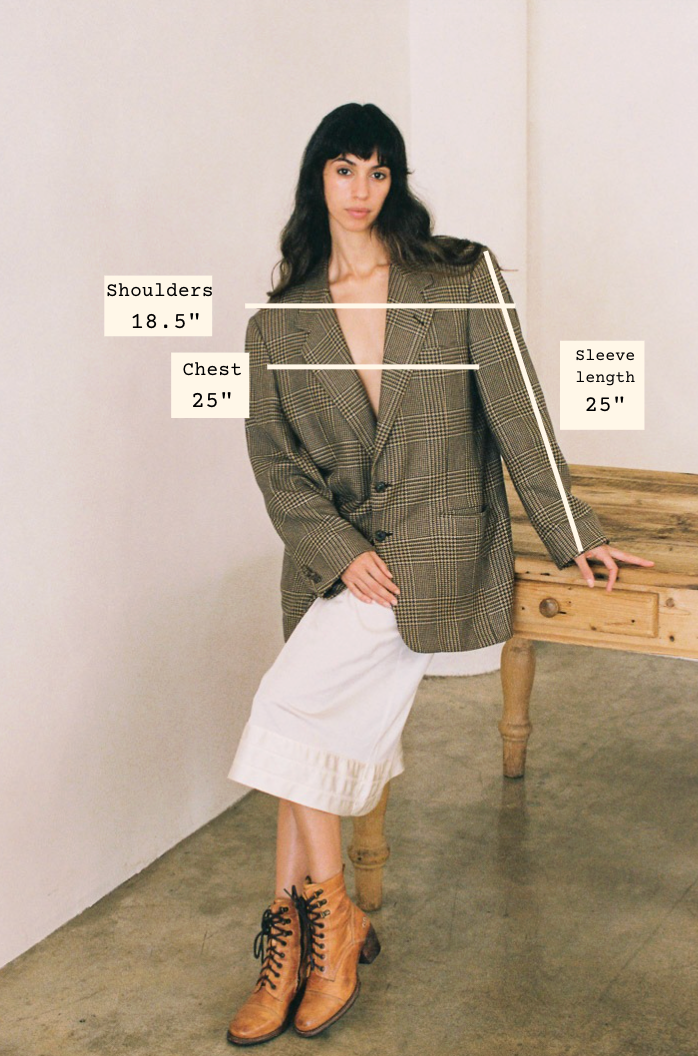 Woman wearing a pliad blazer with measurements labeled on a plain background