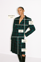 Model wearing a green plaid dress with measurements labeled on a white background