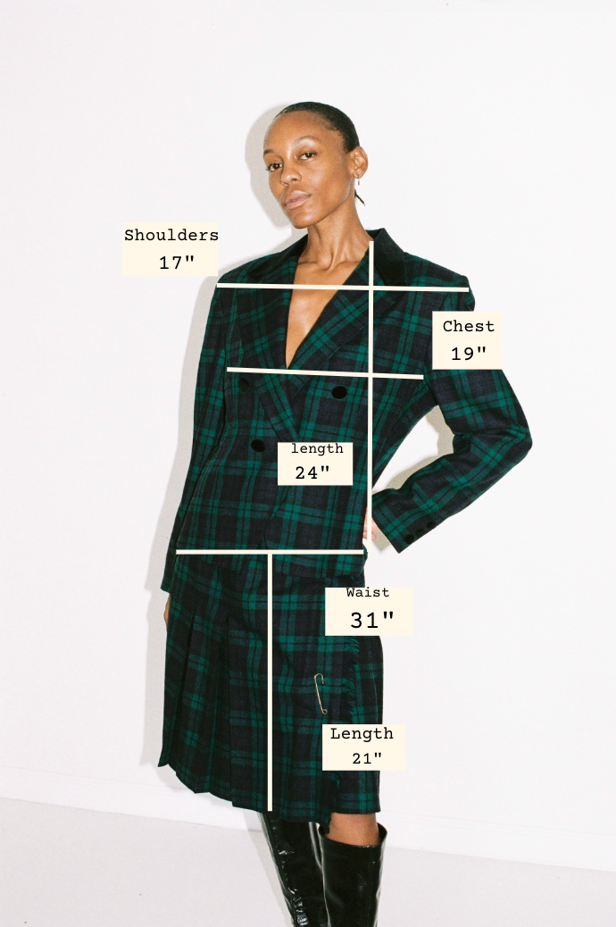 Model wearing a green plaid dress with measurements labeled on a white background