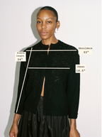 Woman wearing a black jacket with measurements labeled on a white background