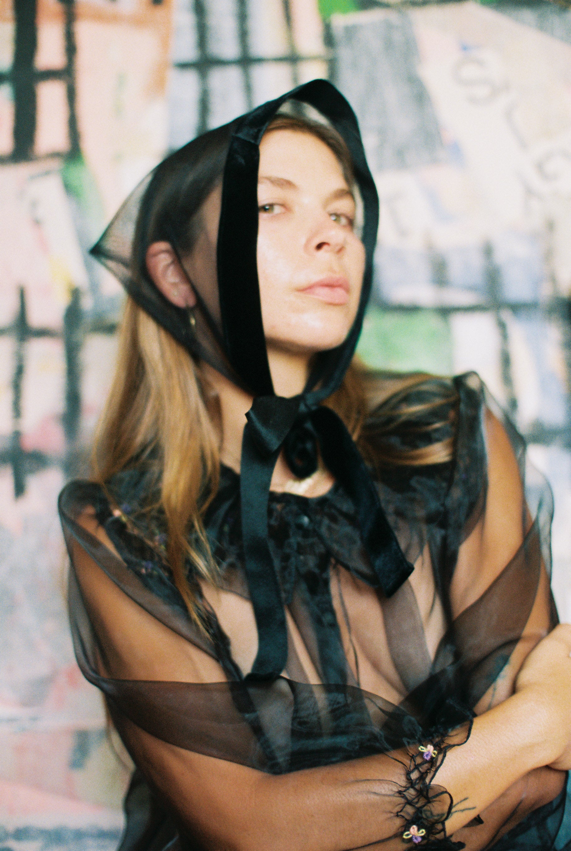 Person wearing a black sheer bonnet with a blurred background