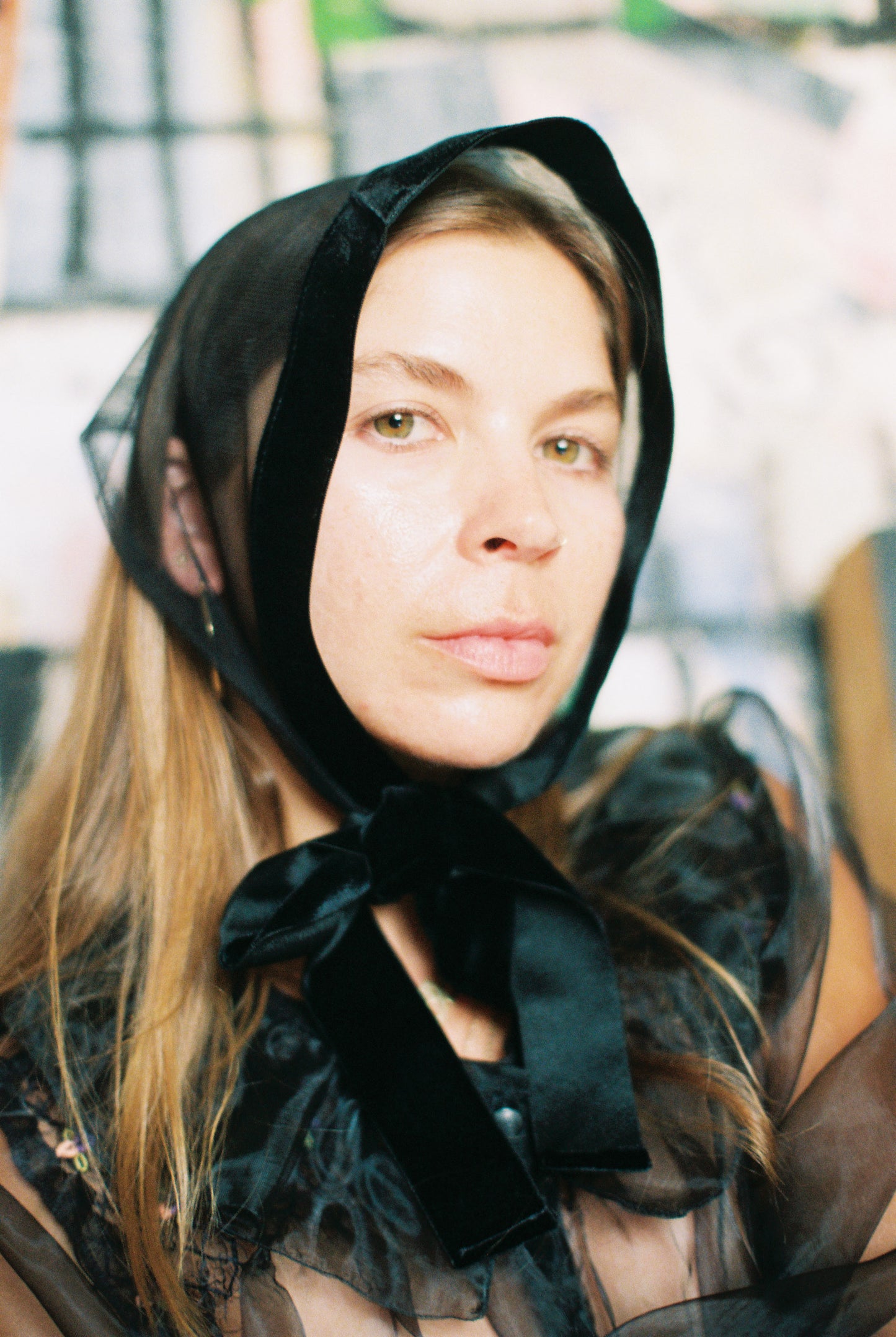 Woman wearing a black headscarf with a blurred background