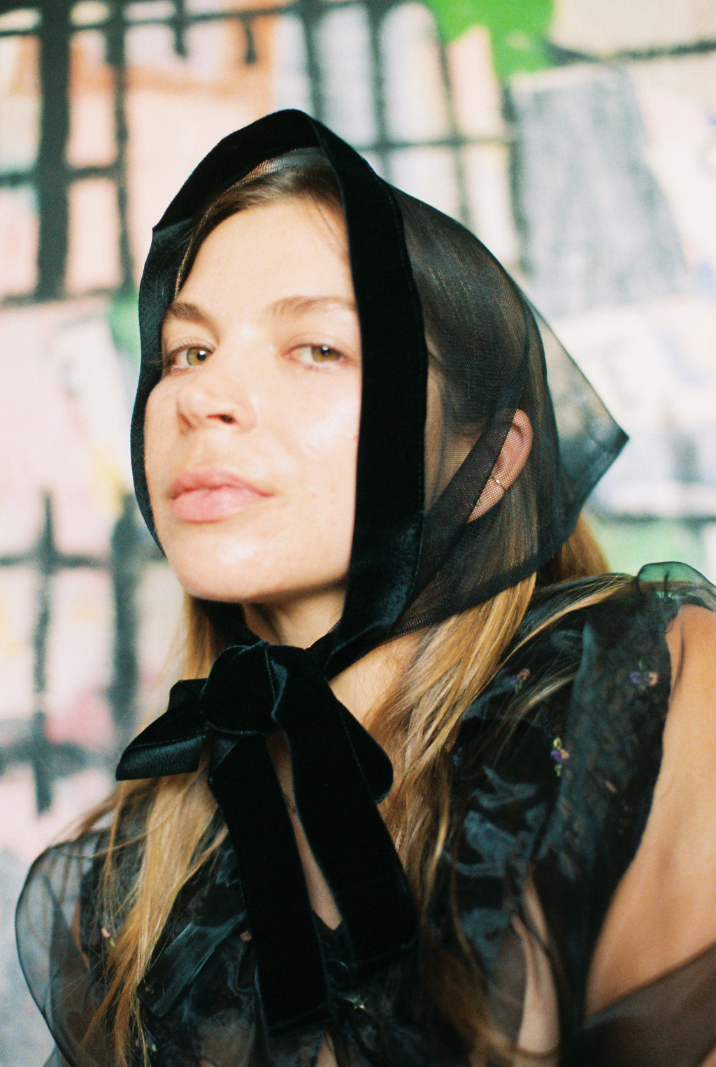 Woman wearing a black headscarf with a blurred background