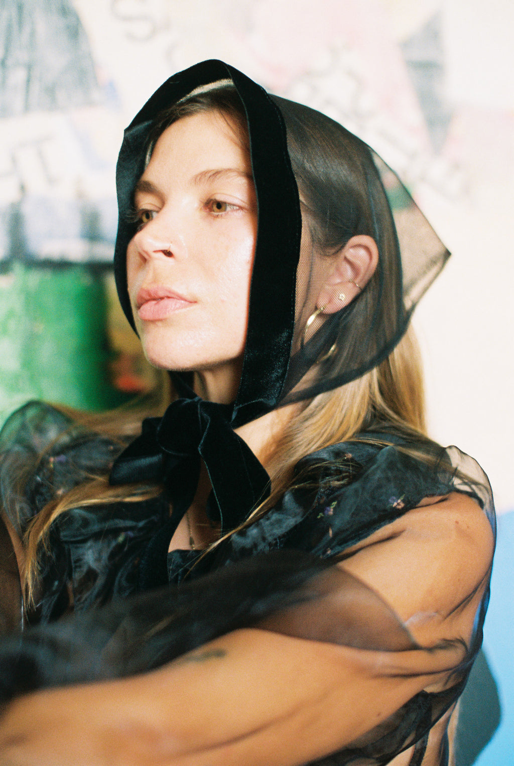 Woman wearing a black sheer headscarf with a blurred background