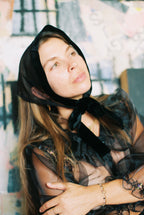 Woman wearing a black headscarf with a blurred background