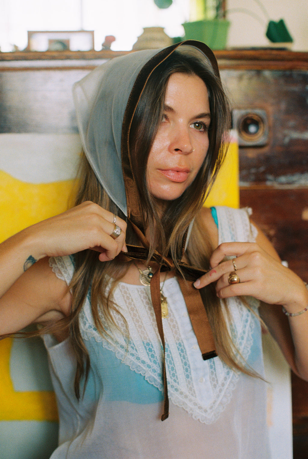 Woman wearing a headscarf with a colorful background