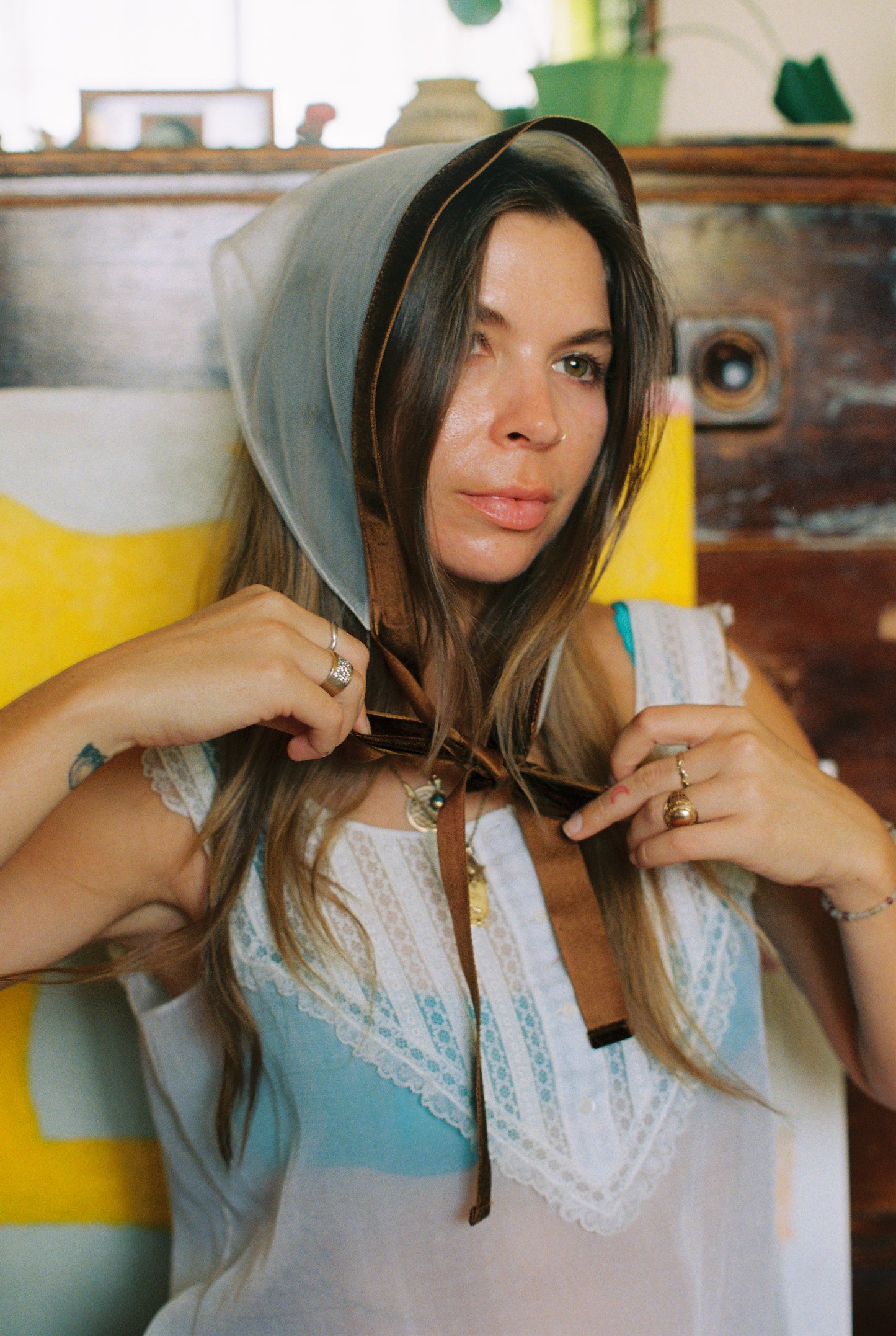 Woman wearing a headscarf with a colorful background