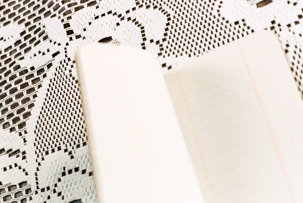 Close-up of a white lace doily with a blurred background